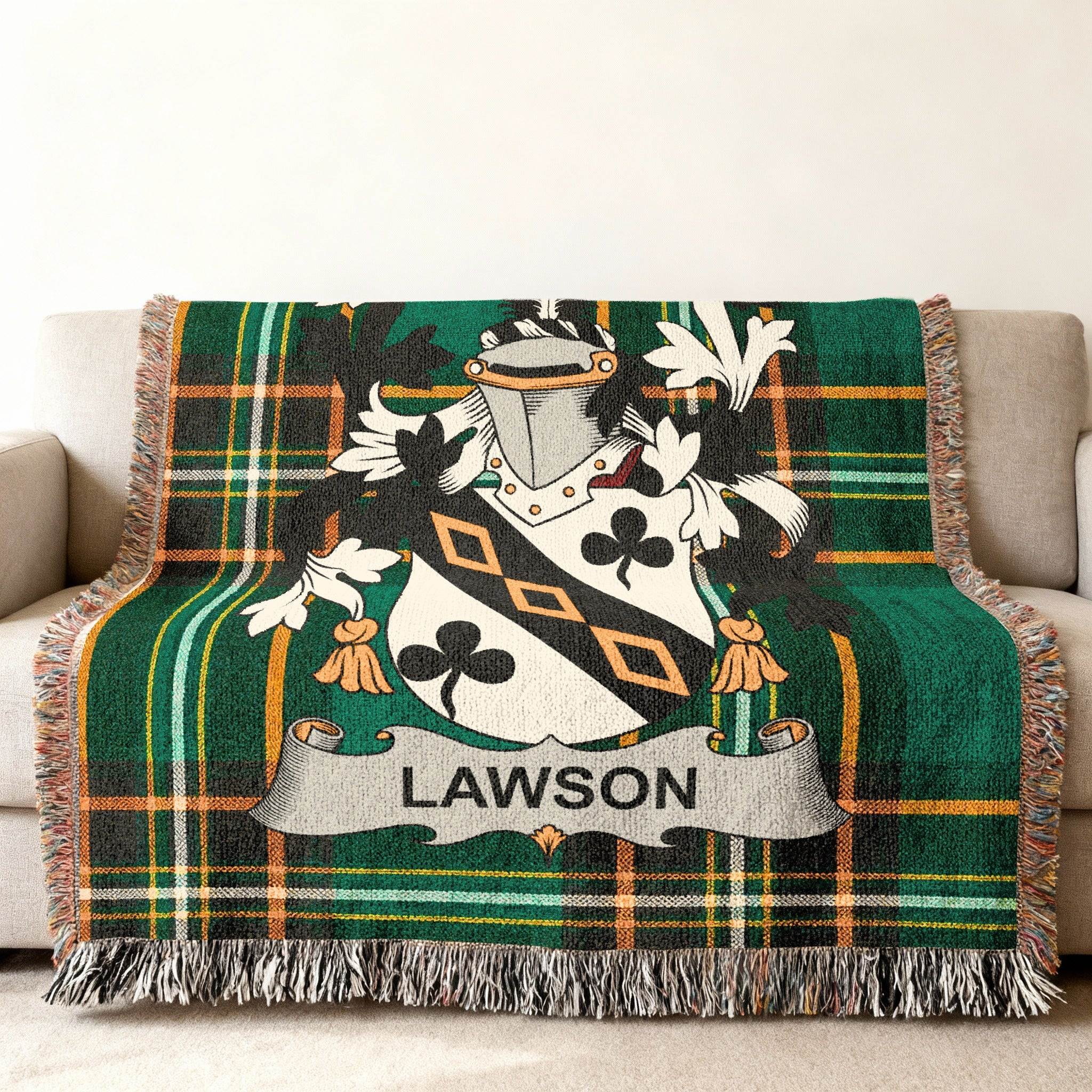 Green plaid throw blanket with Lawson family crest on a couch.