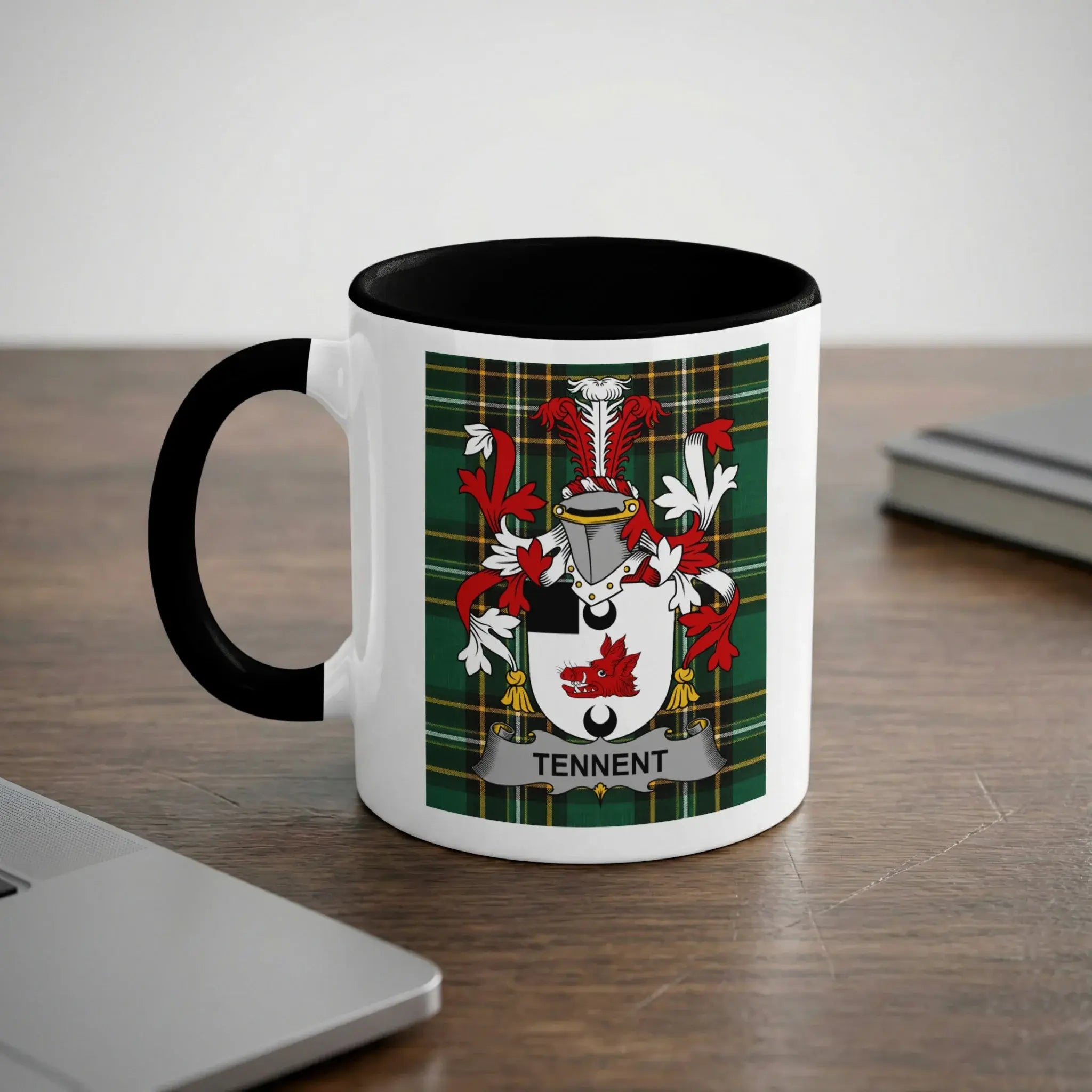 White mug with black handle, featuring a green plaid background and the Tennent coat of arms.