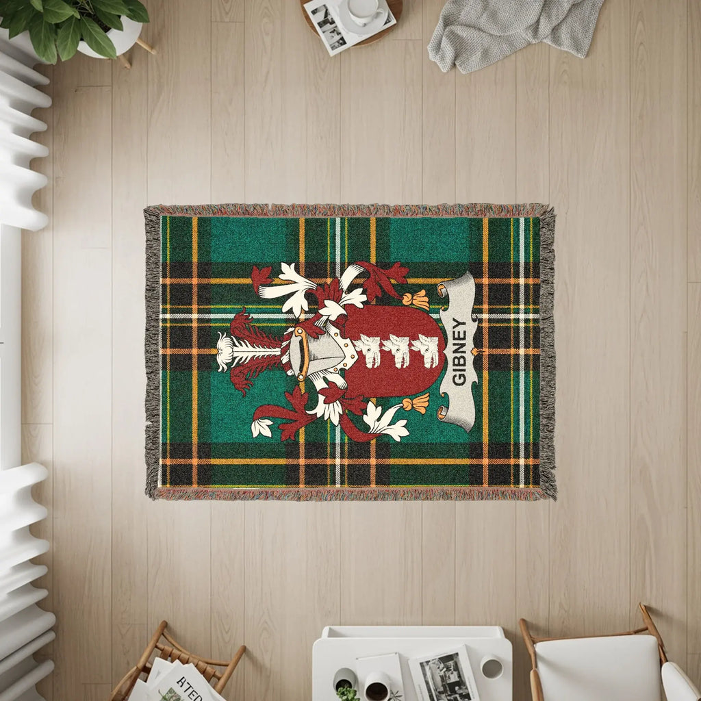 Green plaid woven blanket featuring the Gibney family crest.