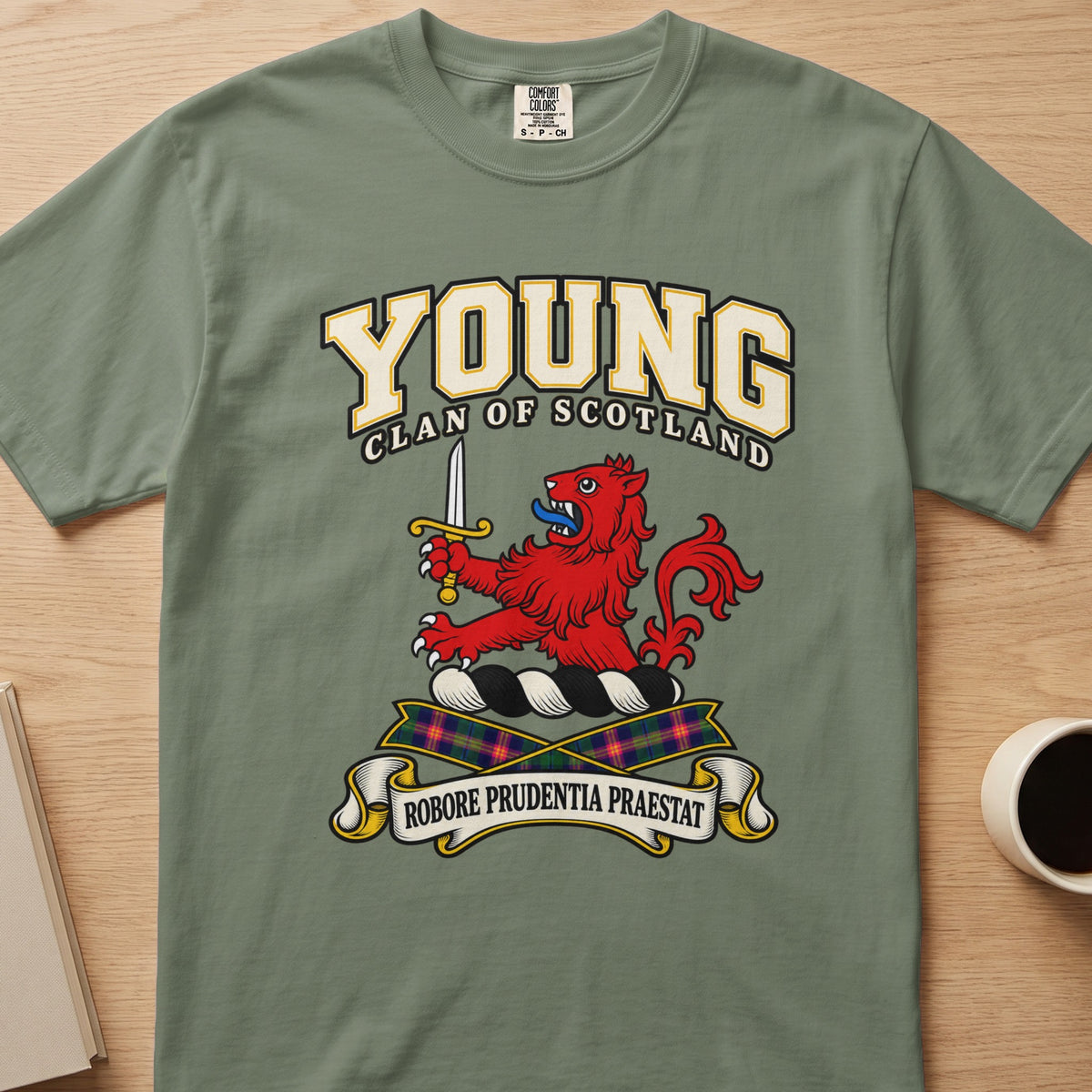 Young red lion with raised sword graphic on a sage green Comfort Colors T-shirt, front view
