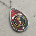 Chisholm clan Scottish tartan necklace with clan crest on tartan background