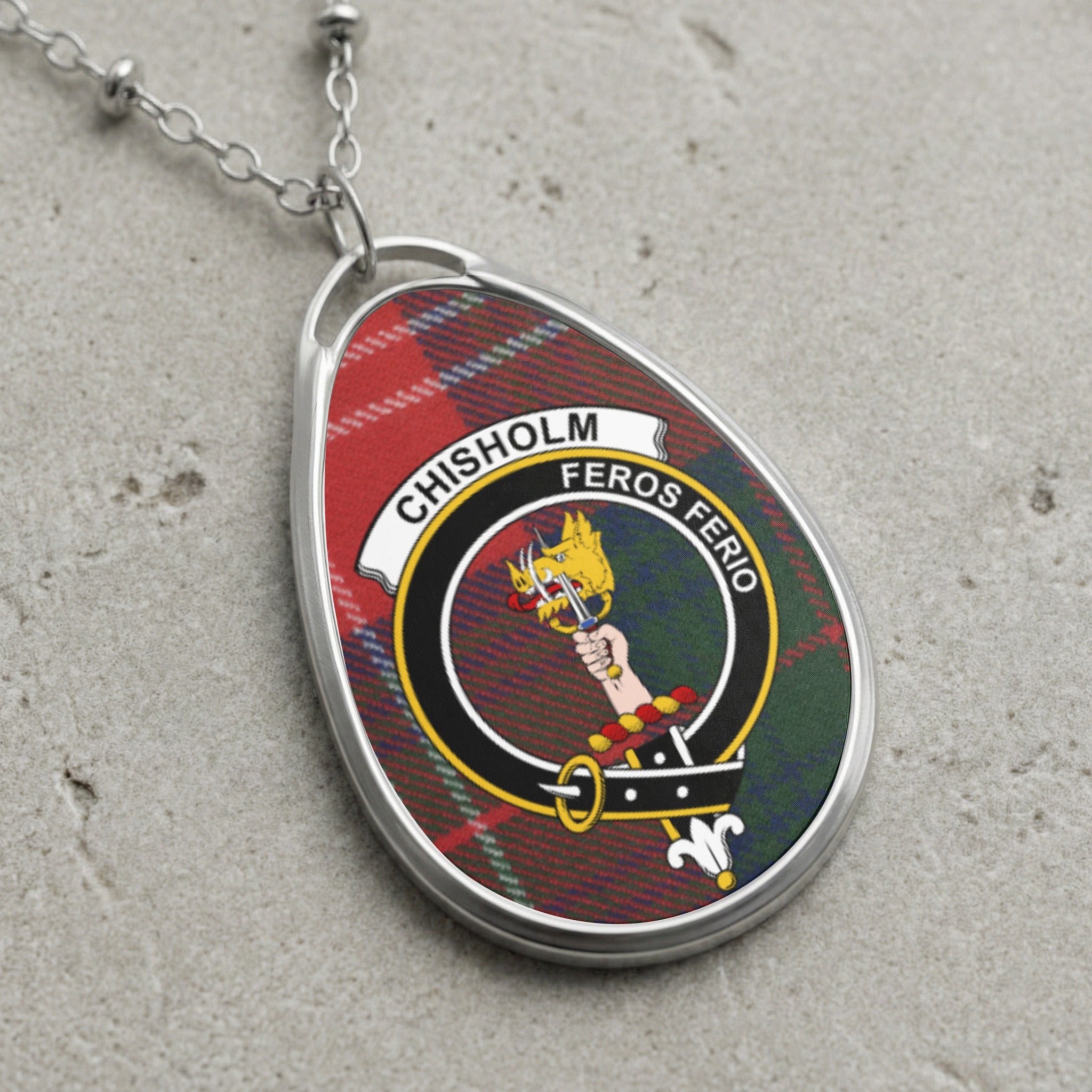 Chisholm clan Scottish tartan necklace with clan crest on tartan background