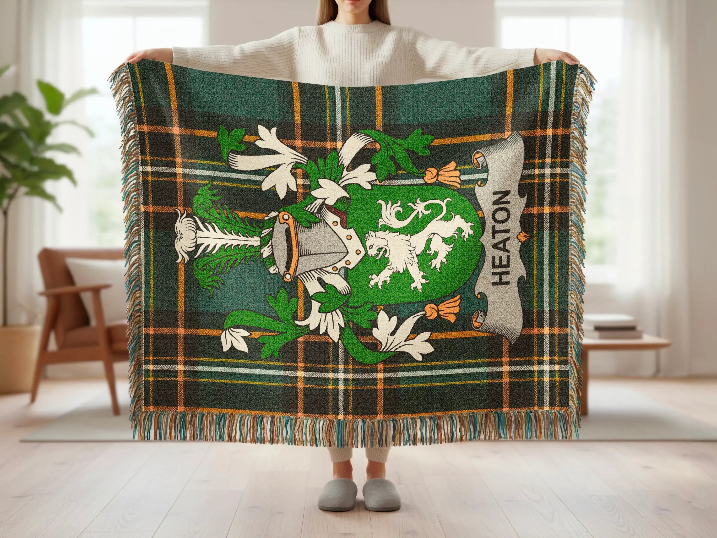 Heaton tartan blanket with coat of arms, held by person.