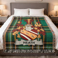 Green tartan throw blanket with a family crest and the name "Heath."