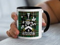 White mug with black rim featuring Woodlock family crest on plaid background.