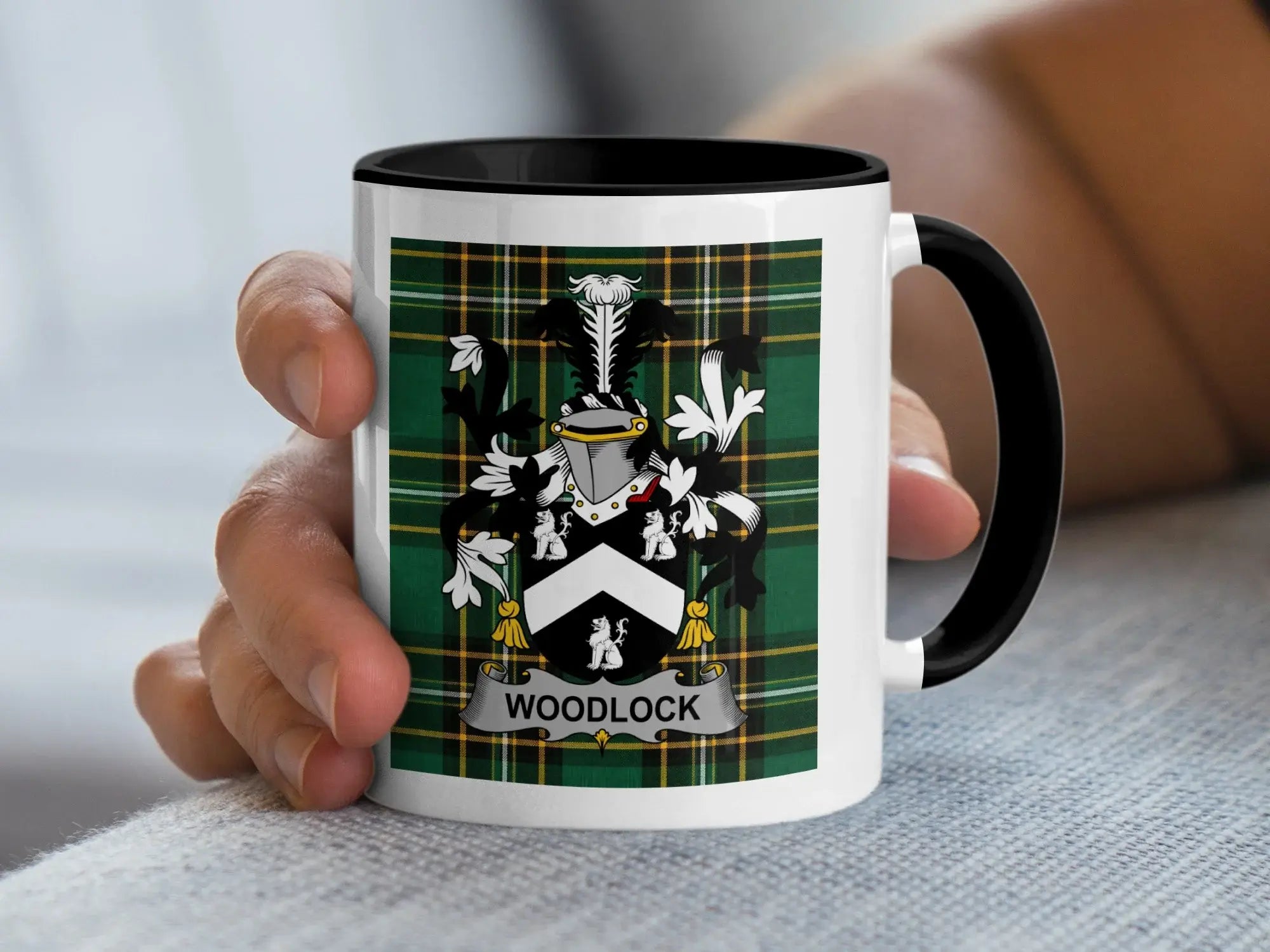 White mug with black rim featuring Woodlock family crest on plaid background.
