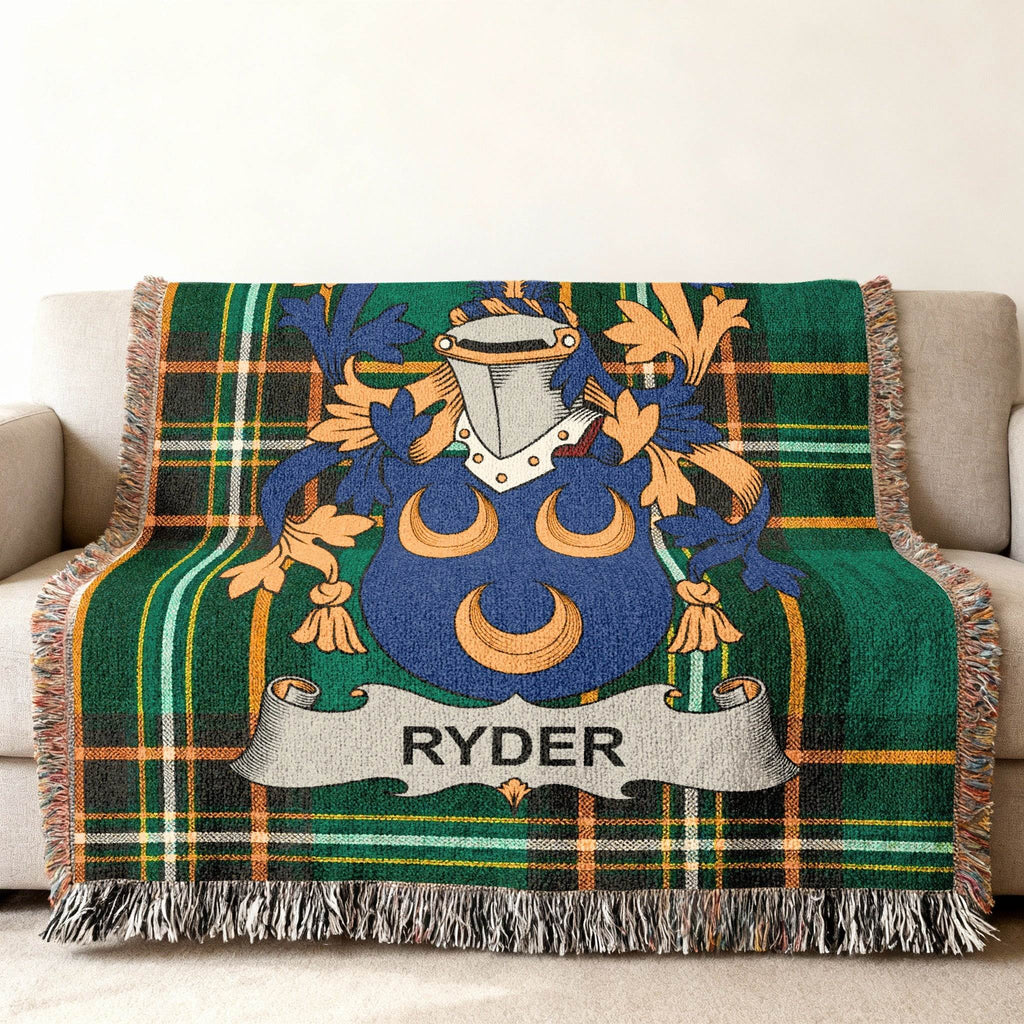 Ryder family crest on green tartan throw blanket draped on sofa.
