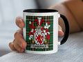 White mug with black rim, featuring a tartan pattern and the Turbville family crest.