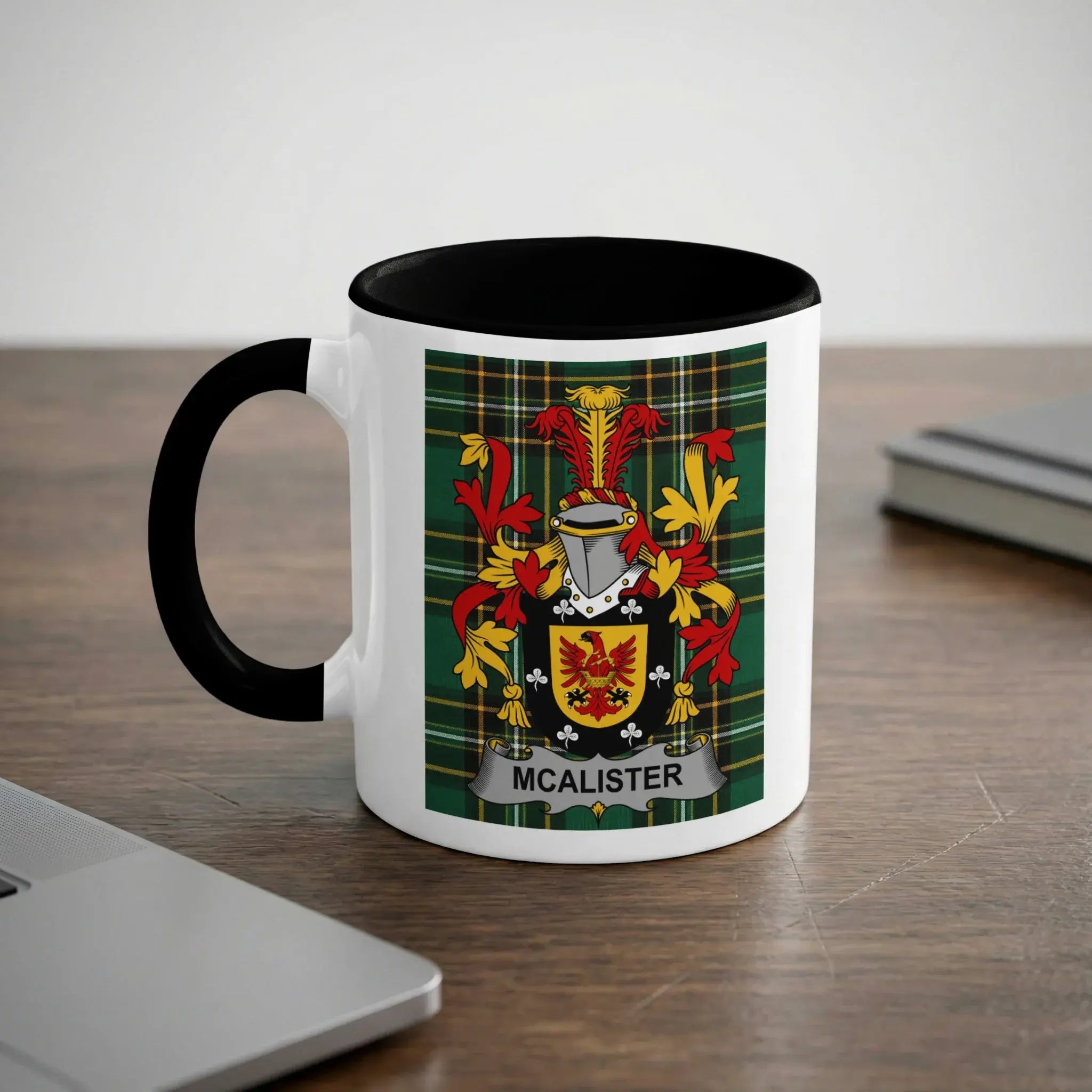 White mug with black rim featuring the McAlister coat of arms on a tartan background.