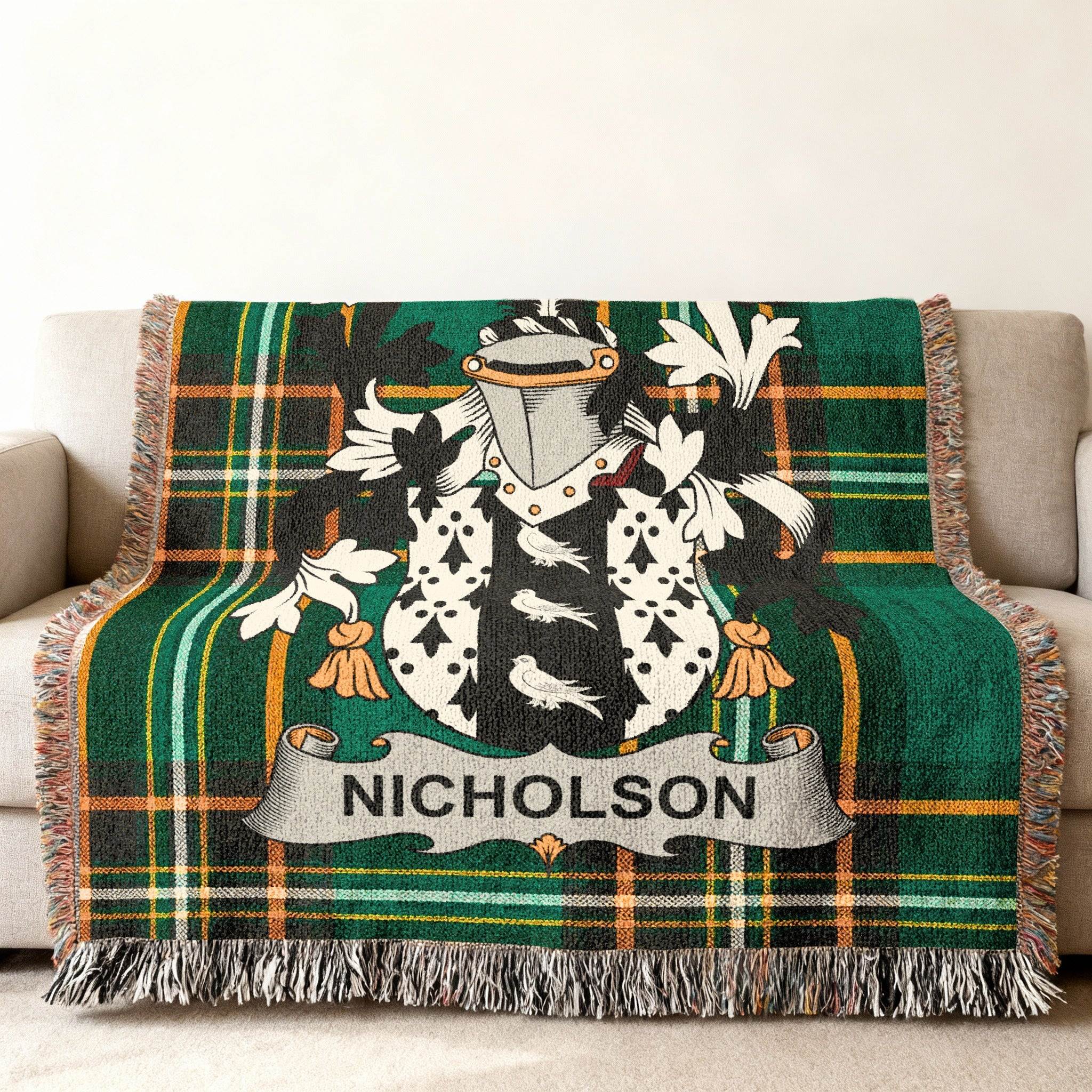 Tartan blanket with Nicholson family crest draped on a sofa.