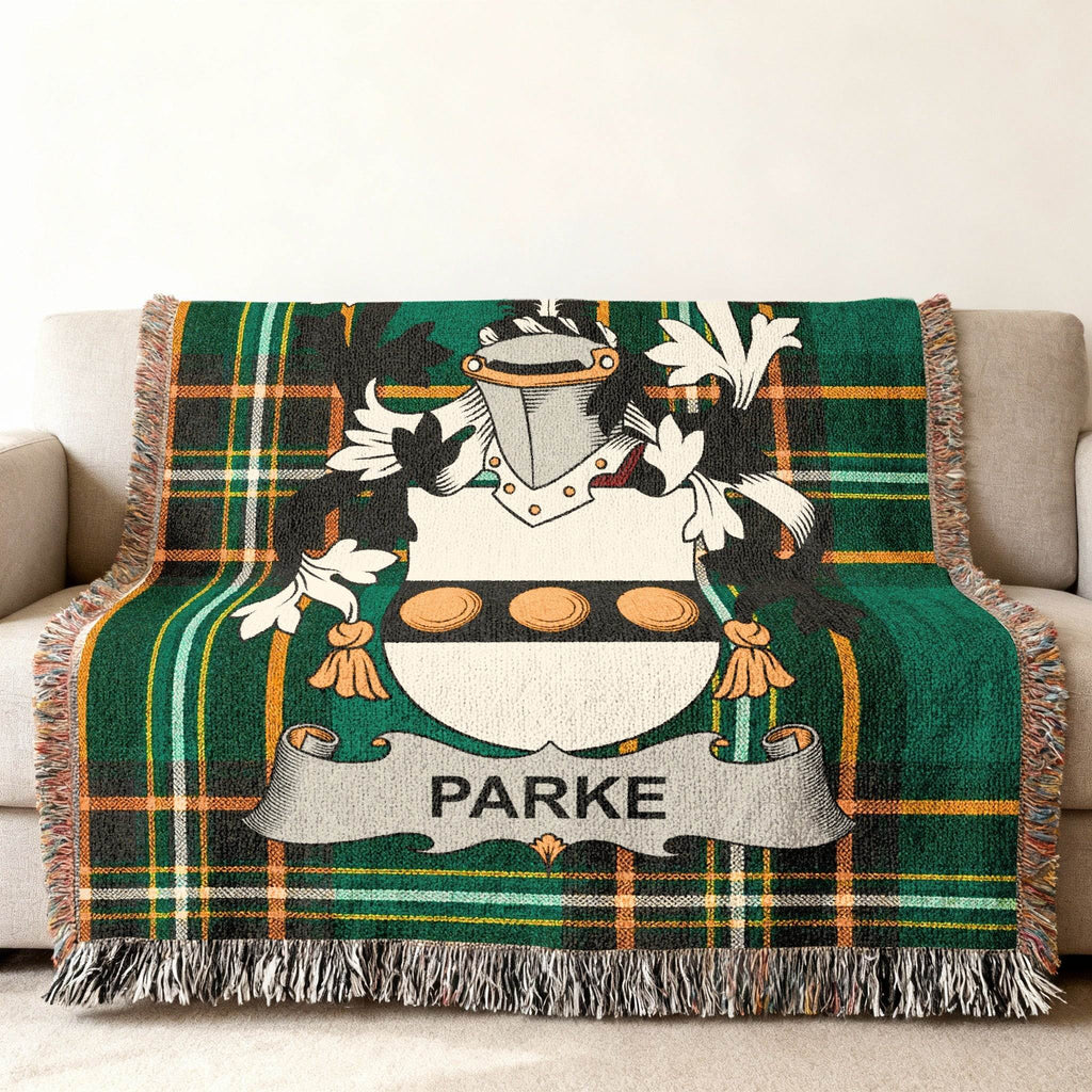 Green tartan blanket with Parke family crest featuring a shield with three discs.
