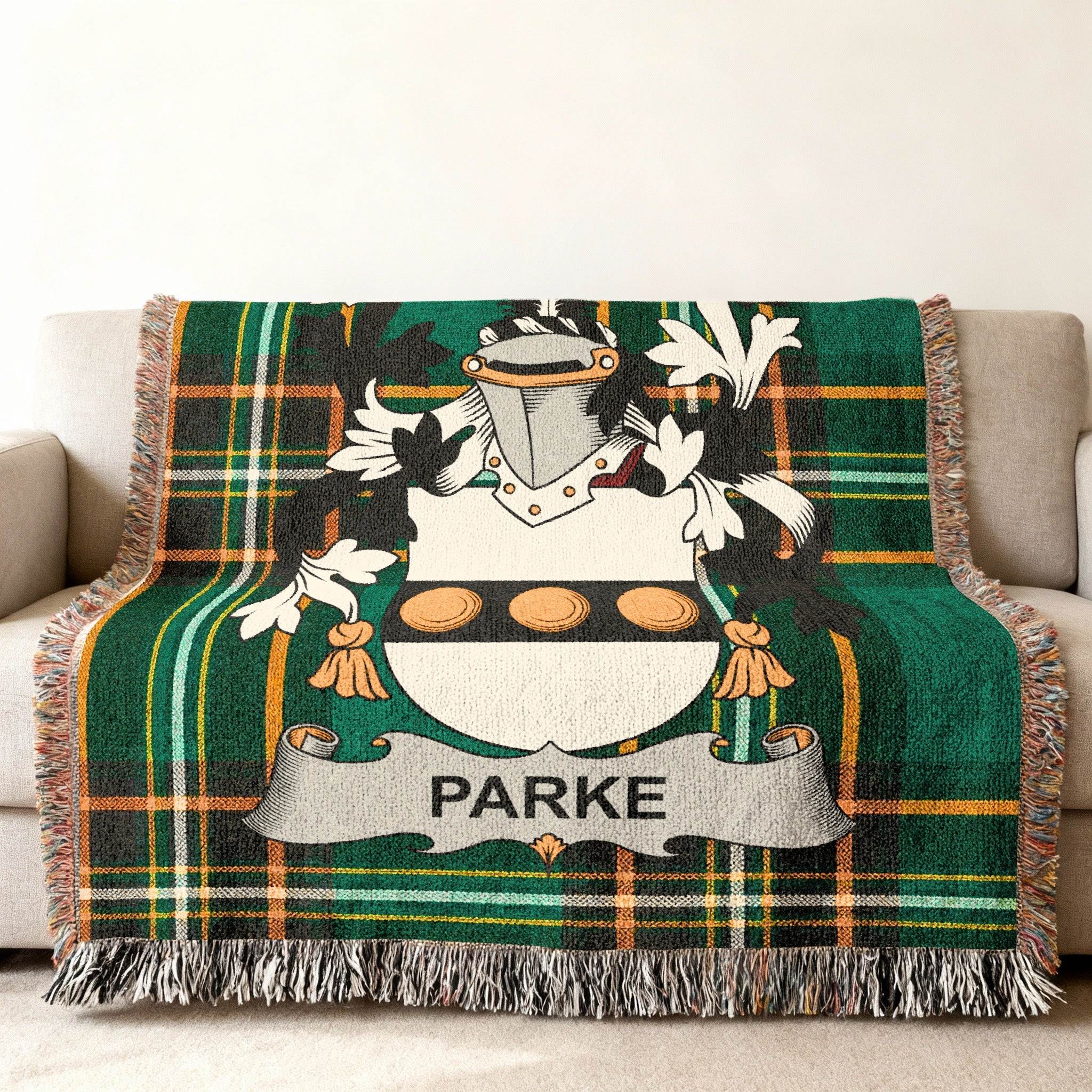 Green tartan blanket with Parke family crest featuring a shield with three discs.