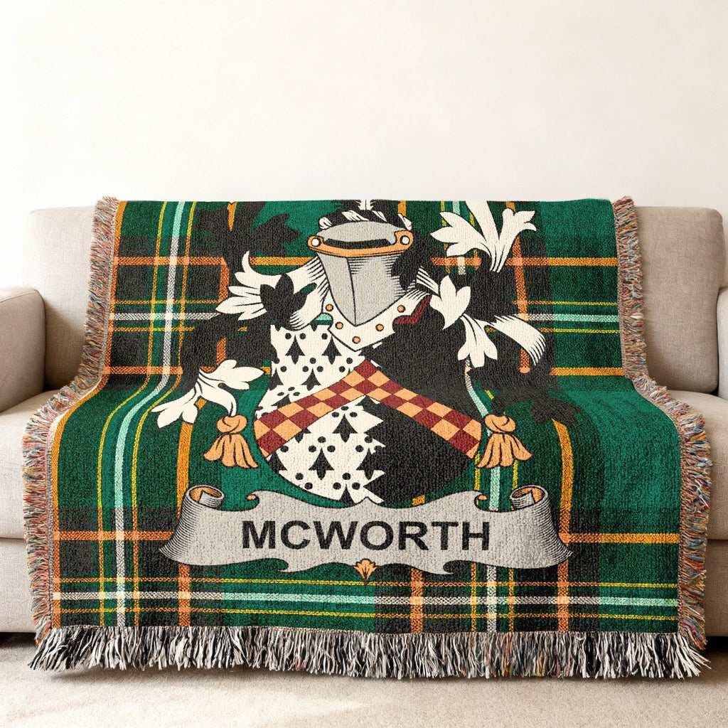 McWorth family crest on a green plaid woven throw blanket with fringe.