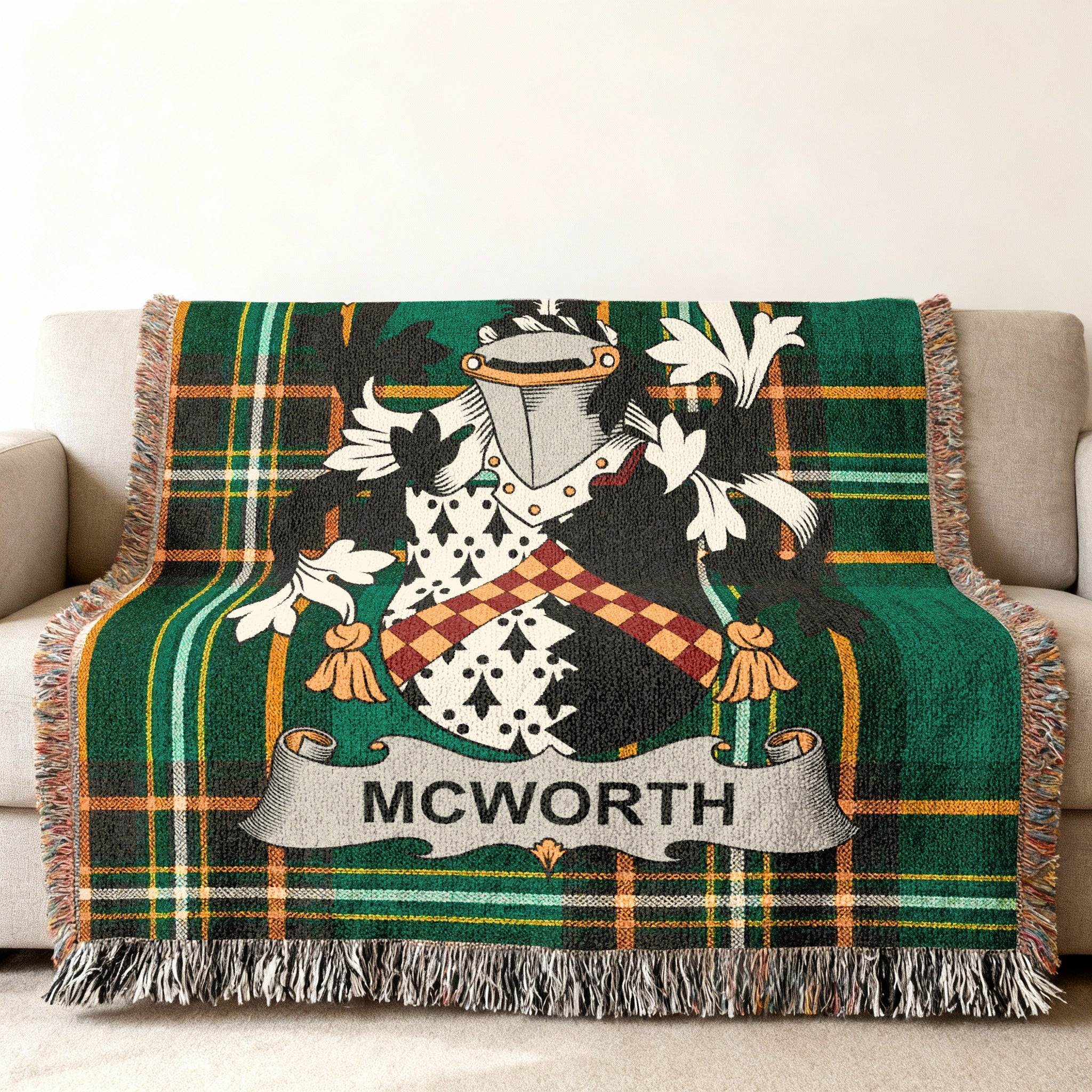 McWorth family crest on a green plaid woven throw blanket with fringe.