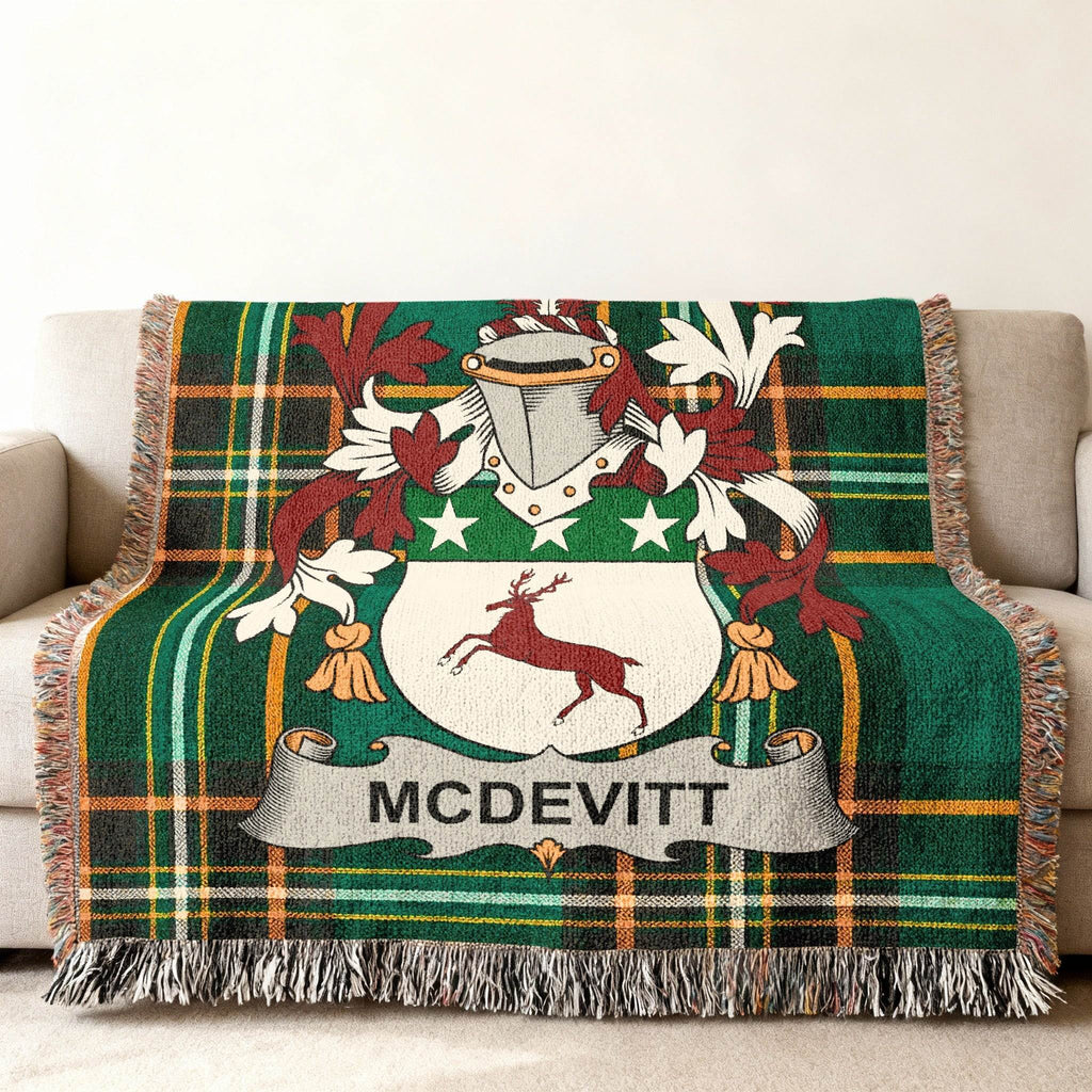 Green plaid throw blanket with McDevitt family crest featuring a deer and shield.