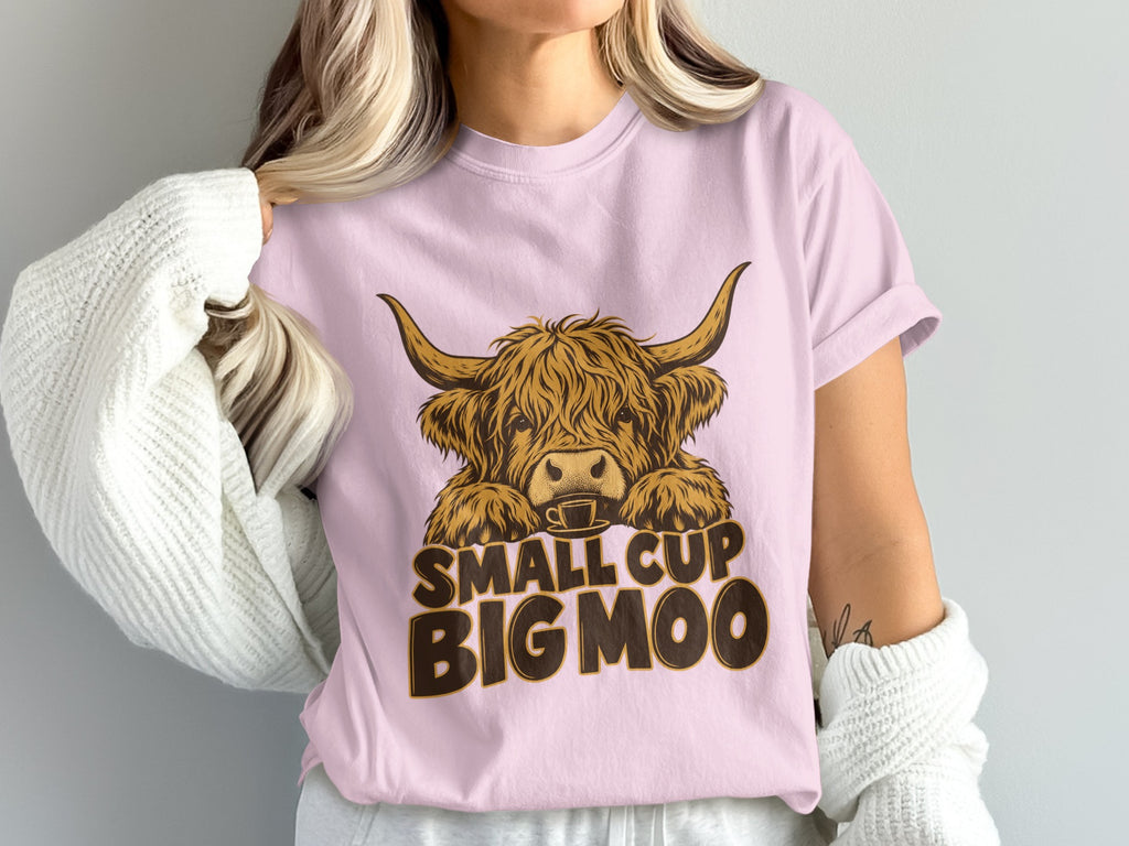 Model wearing the Small Cup, Big Moo Highland cow Comfort Colors T-shirt in Blossom