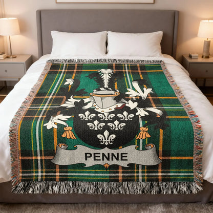 Tartan blanket with green and black plaid and a family crest bearing the name PENNE.