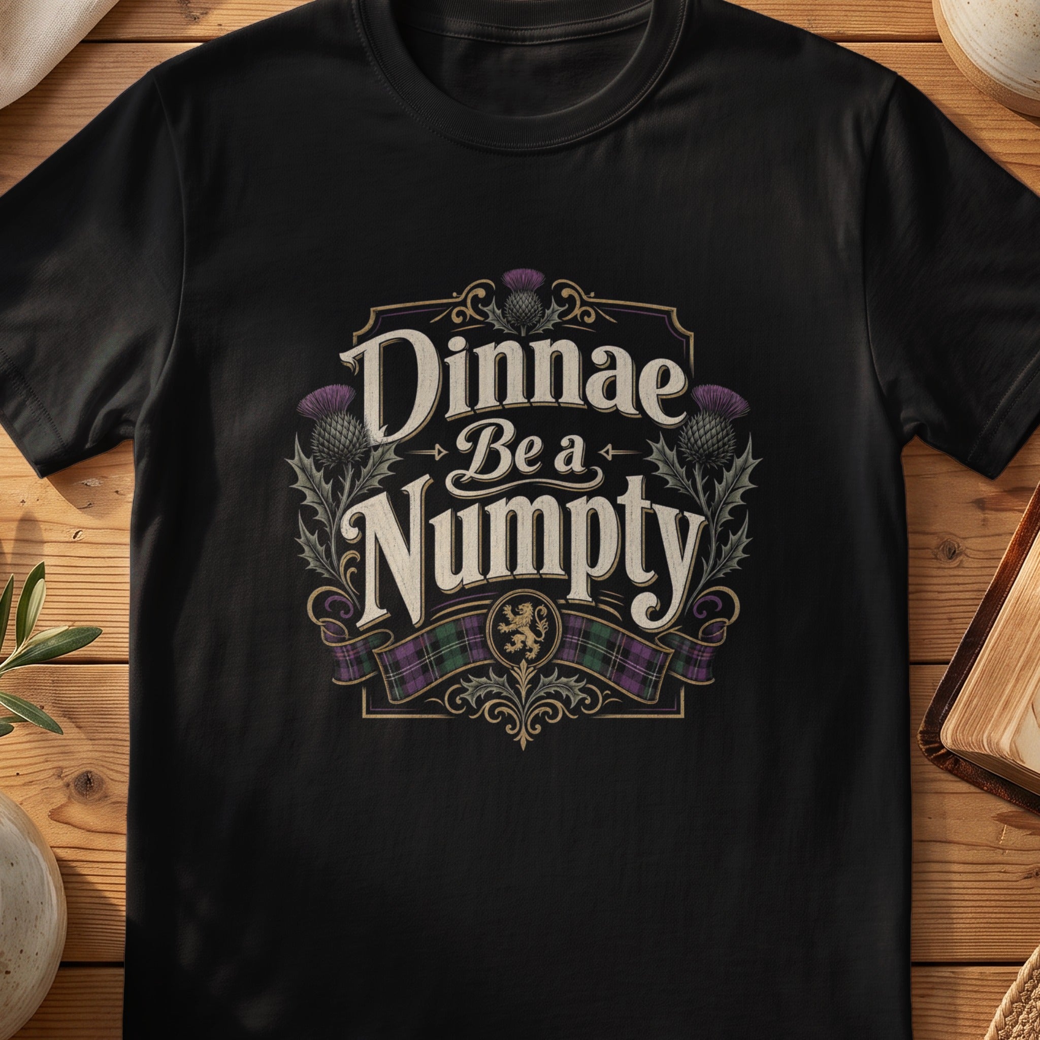 Black Gildan 64000 unisex T-shirt flatlay with Dinnae Be a Numpty Scottish graphic design
