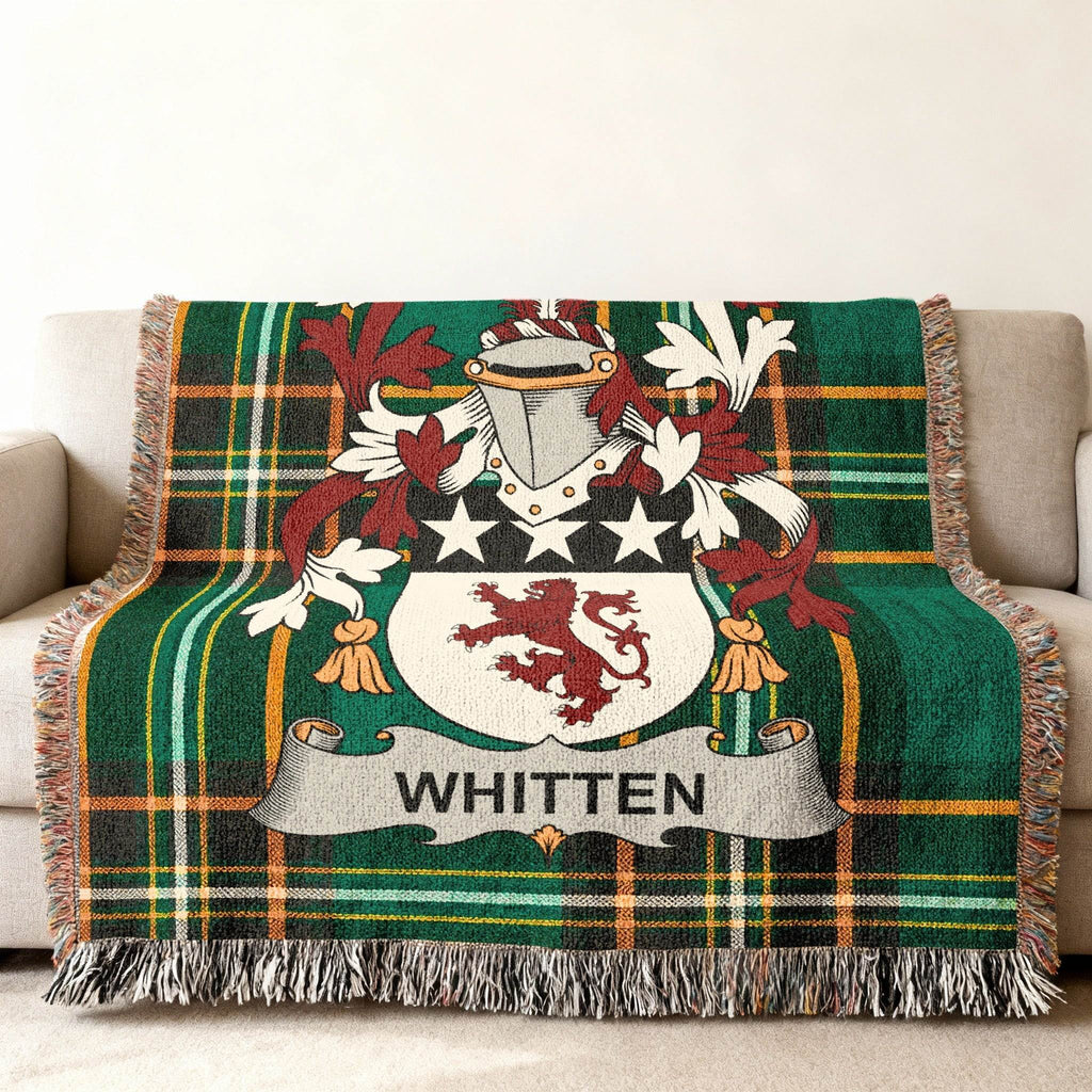 Green plaid throw blanket with Whitten family crest.