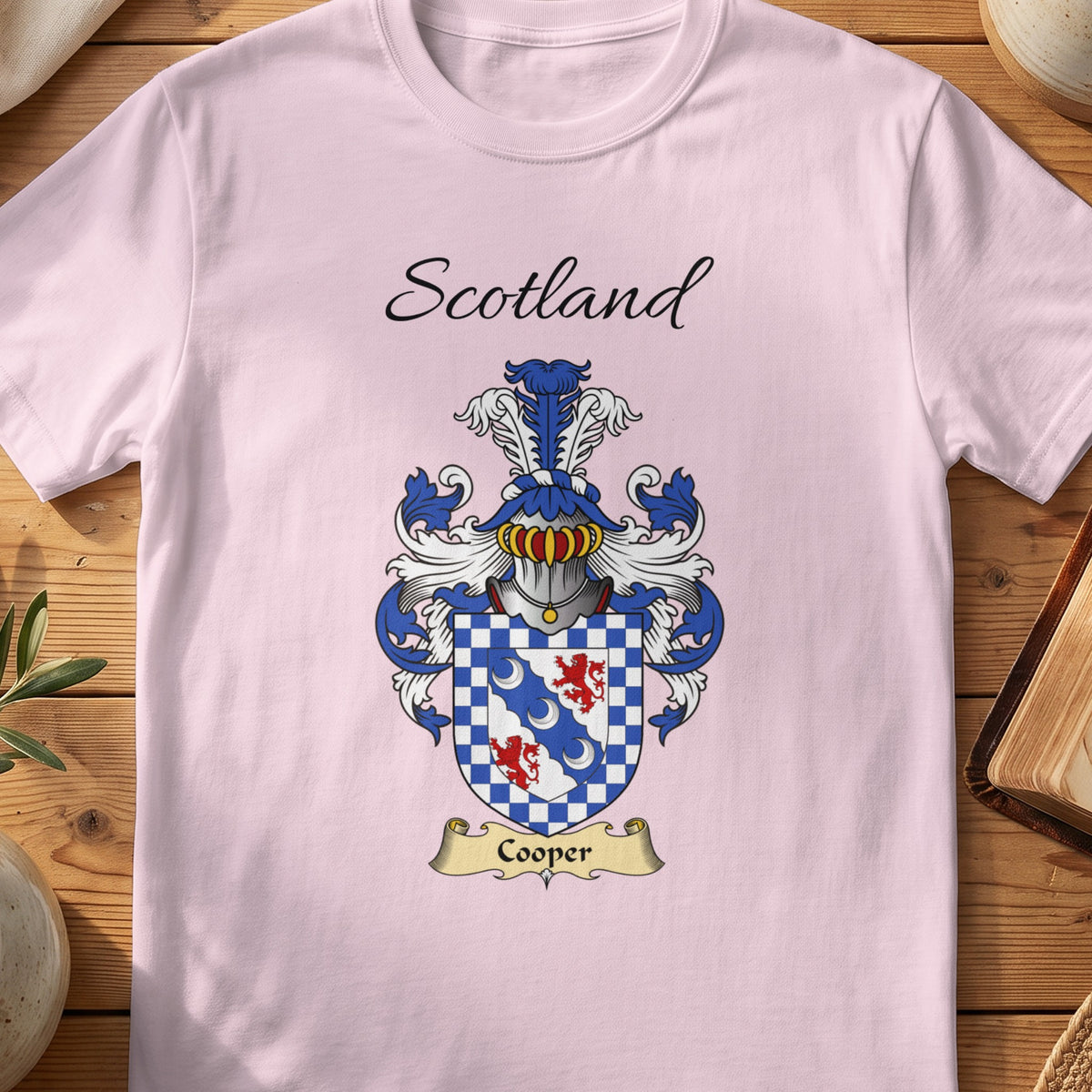 Light Pink Cooper Scottish family shield T-shirt featuring a blue diagonal band inside a checked border