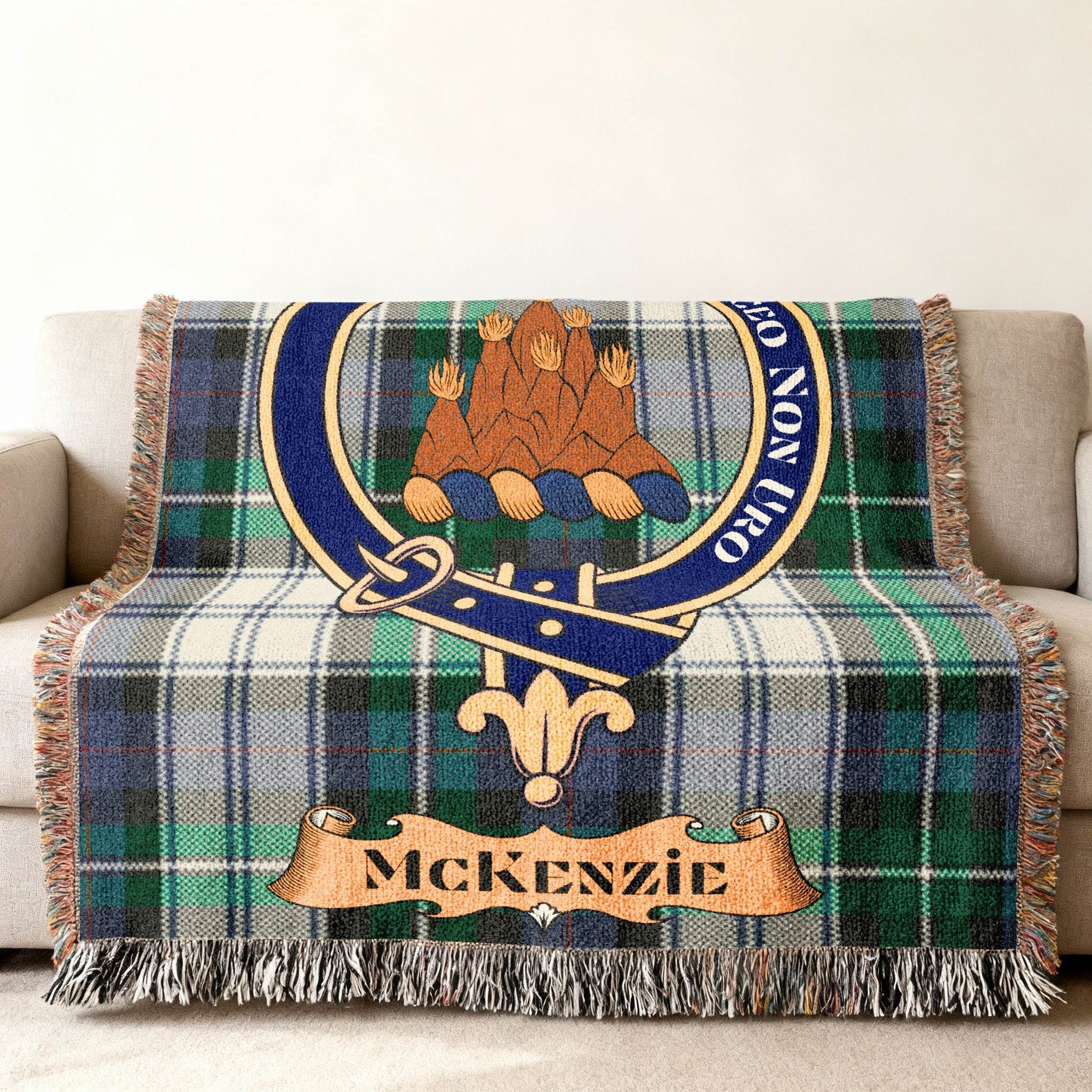MacKenzie clan crest and tartan design woven blanket — fringe edge visible, 100% cotton