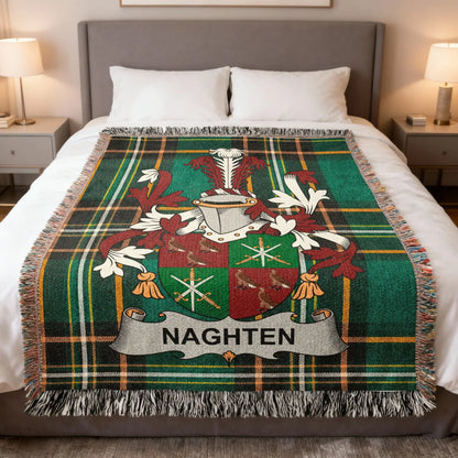 Plaided blanket with Naghten family crest on a bed.