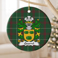 Quarrel round Welsh National Tartan ornament hanging from a pale wooden branch, featuring three green barrels on a gold shield.