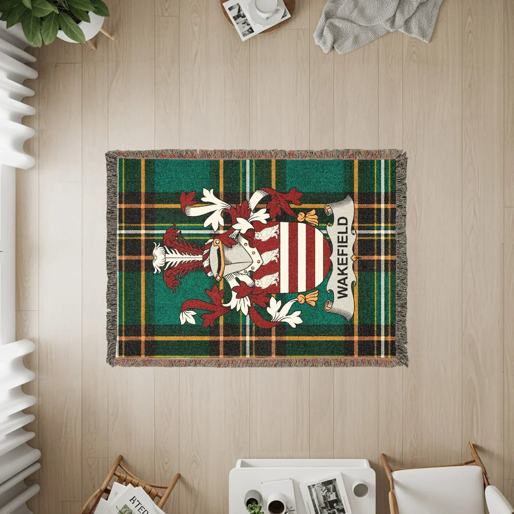Green plaid blanket with Wakefield crest and banner, draped on floor.