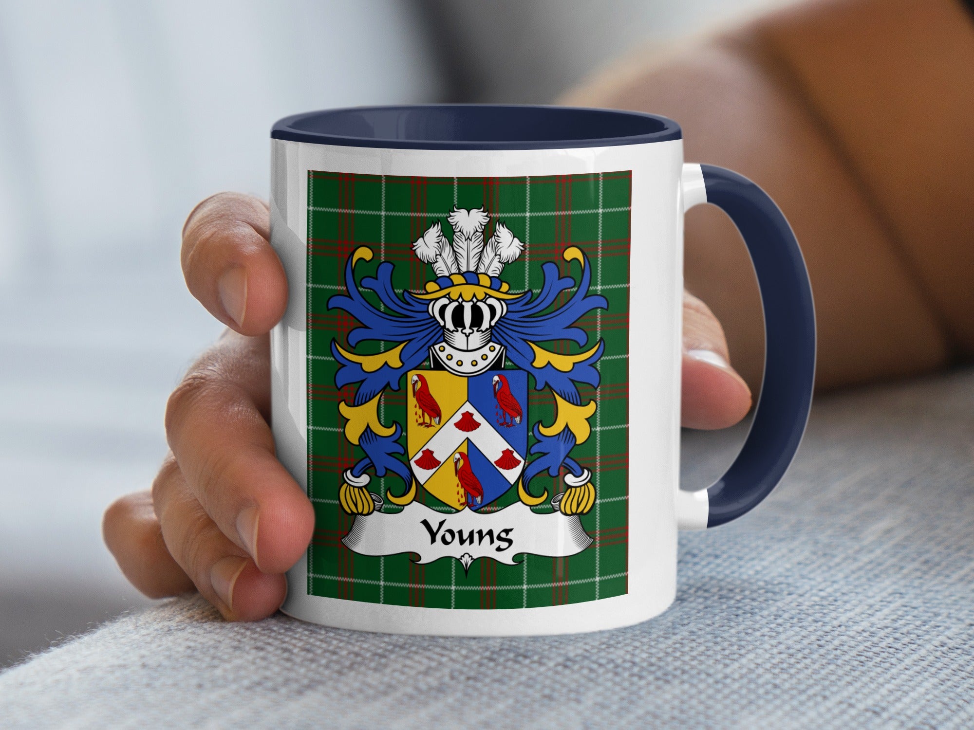 Mug with dark blue handle featuring the "Youngs" crest on a green tartan pattern.