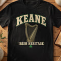 Keane Irish harp T-shirt in Black, with cream surname lettering, a gold-toned harp, green shamrock and “Irish Heritage” text.