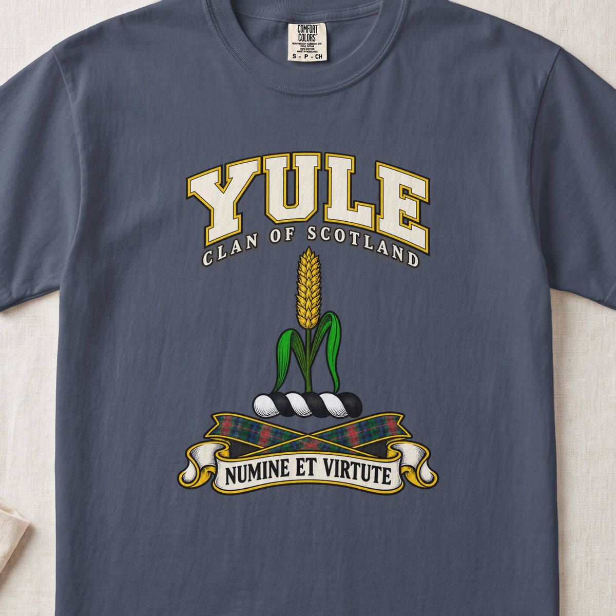 Yule Scottish clan T-shirt in Midnight, front view with a golden ear of grain with green leaves and motto design.