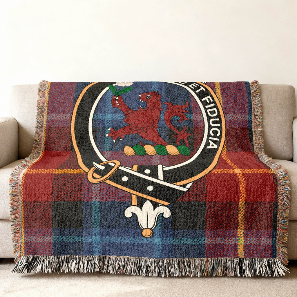 Primrose tartan woven blanket folded — showing crest and red plaid design