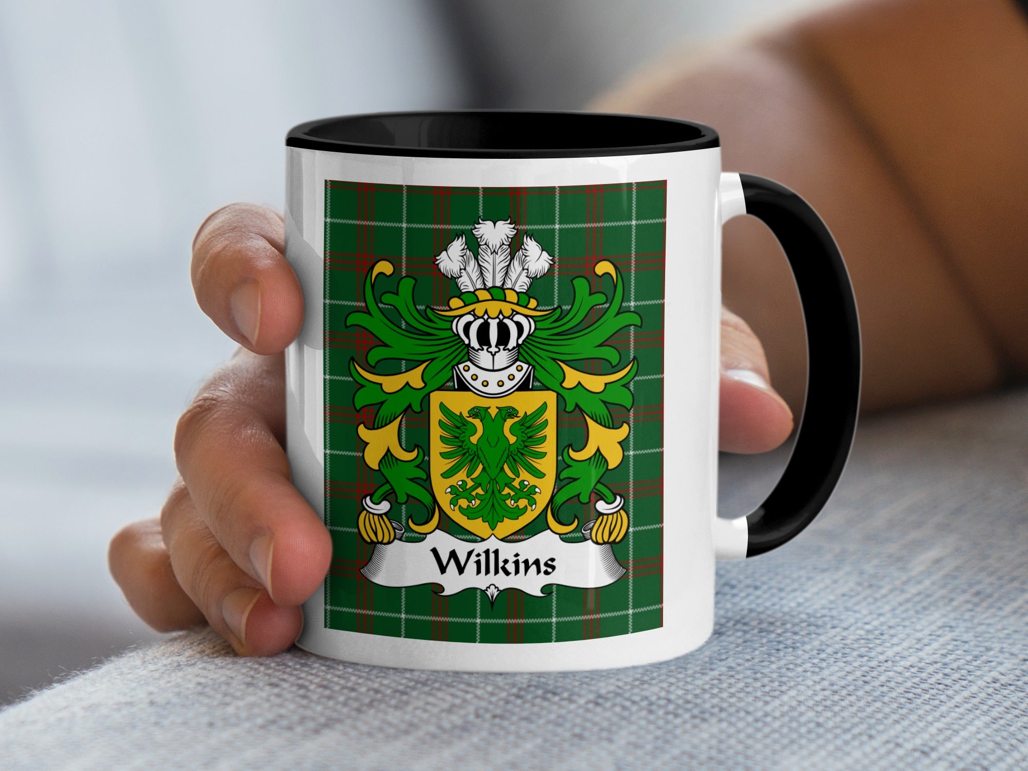 White mug with Wilkins coat of arms on green tartan background.