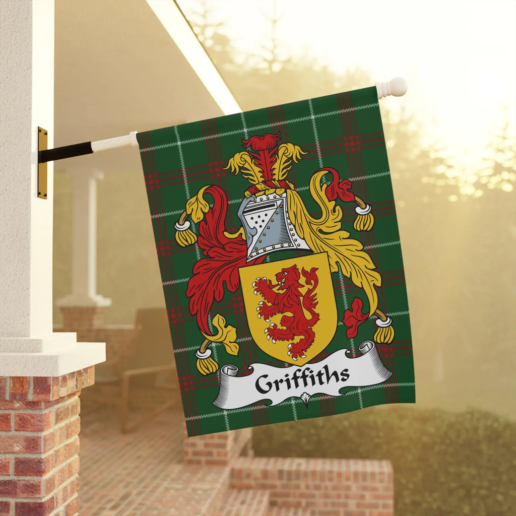 Griffiths family crest on a green plaid flag, displayed outdoors.