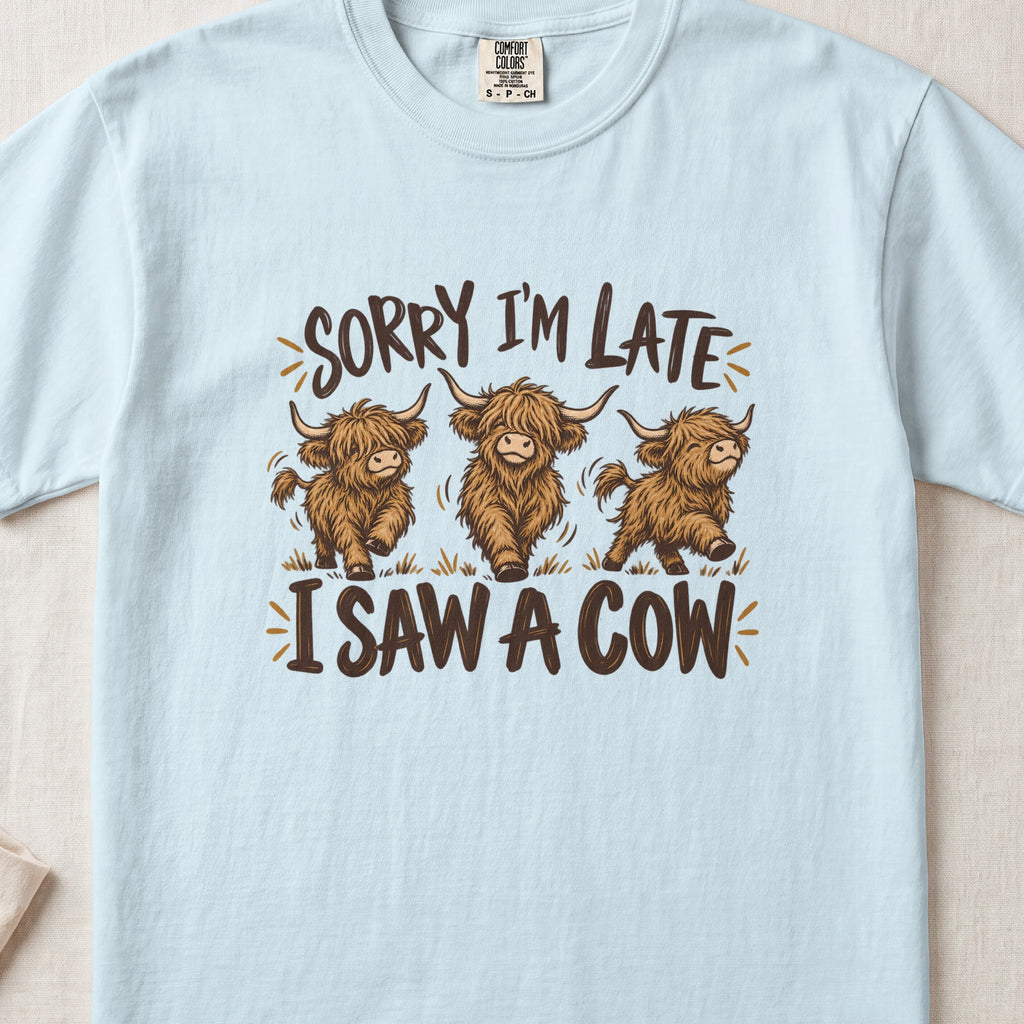 Sorry I'm Late, I Saw a Cow Highland cow design on a Chambray Comfort Colors 1717 T-shirt, flat lay