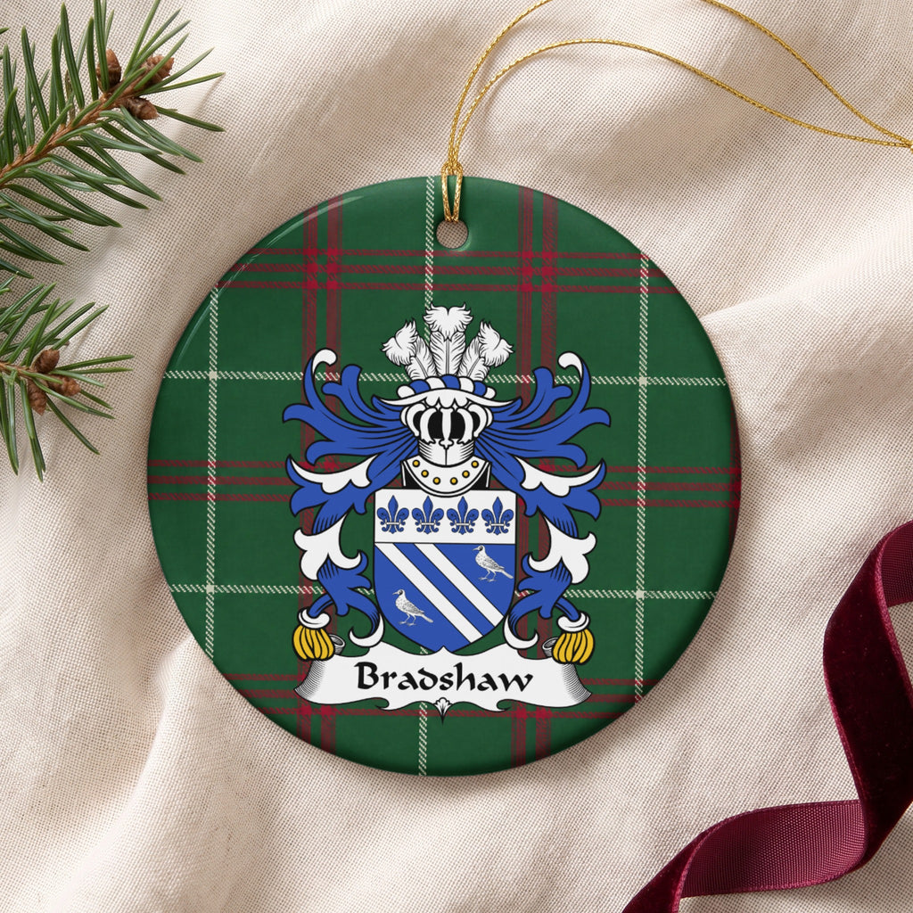 Bradshaw ornament on cream fabric with gold string, evergreen and burgundy ribbon; two white diagonal bands and two white birds on blue beneath four blue fleurs-de-lis on Welsh national tartan.