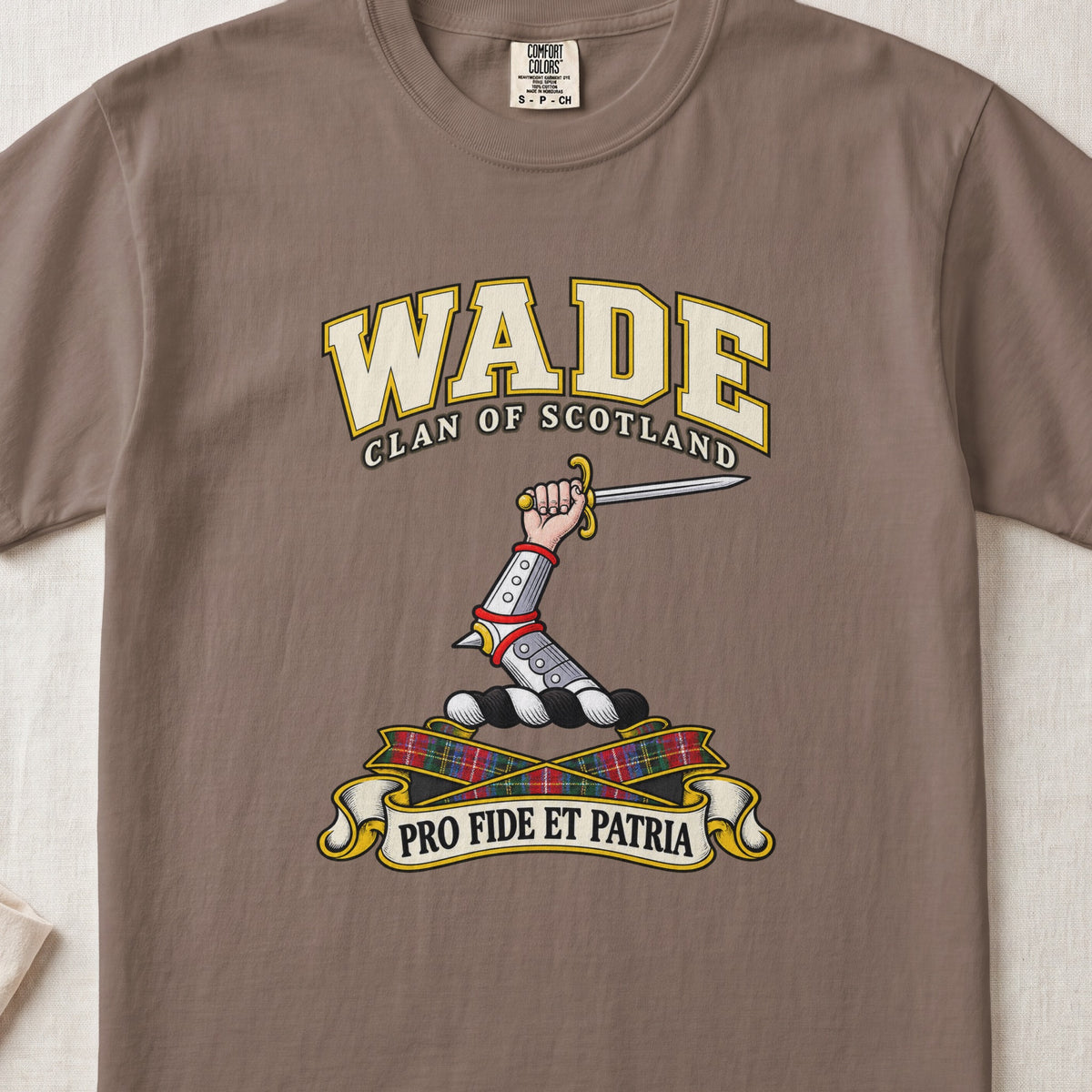 Wade Scottish clan T-shirt in Espresso, front view with an armoured arm holding a sword and motto design.