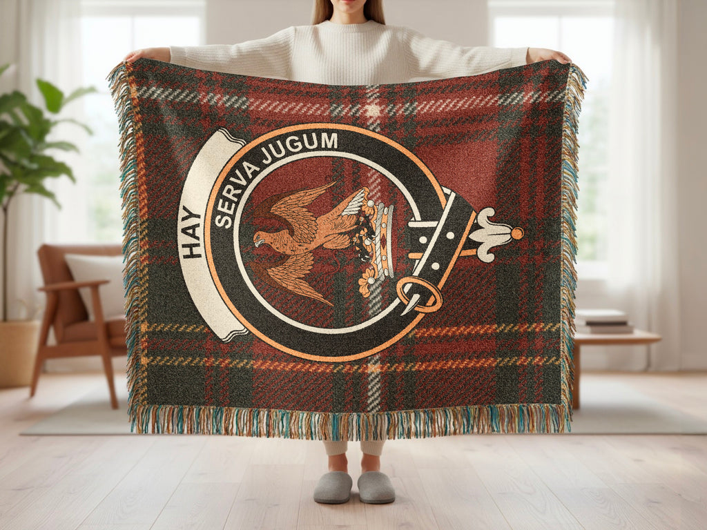 Hay Serva Jugum clan crest close-up on tartan woven blanket