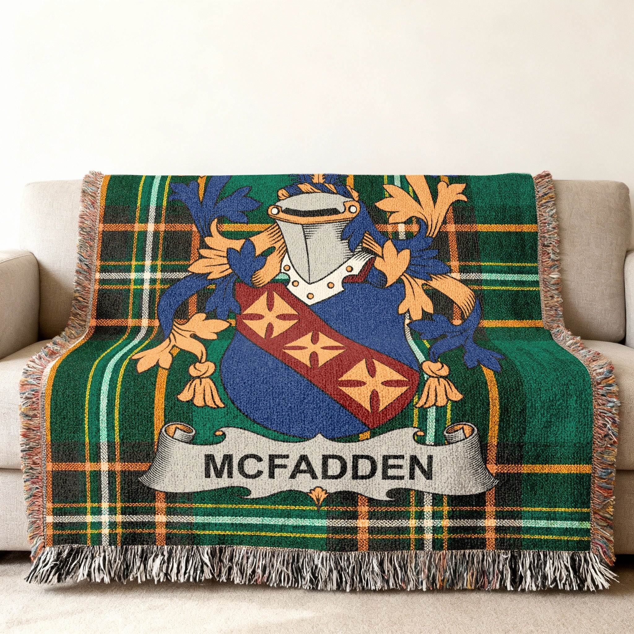 McFadden family crest on green plaid throw blanket with fringe.
