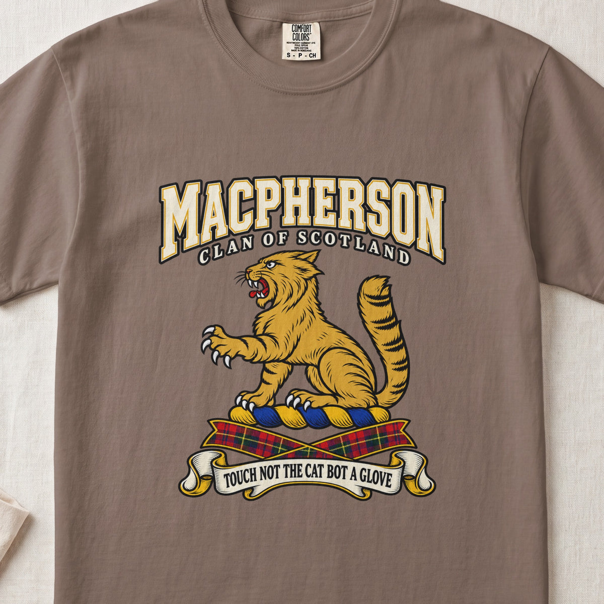 MacPherson graphic T-shirt in Espresso brown, front flat lay showing varsity lettering and seated gold wildcat with black stripes, raised paw and upright tail.