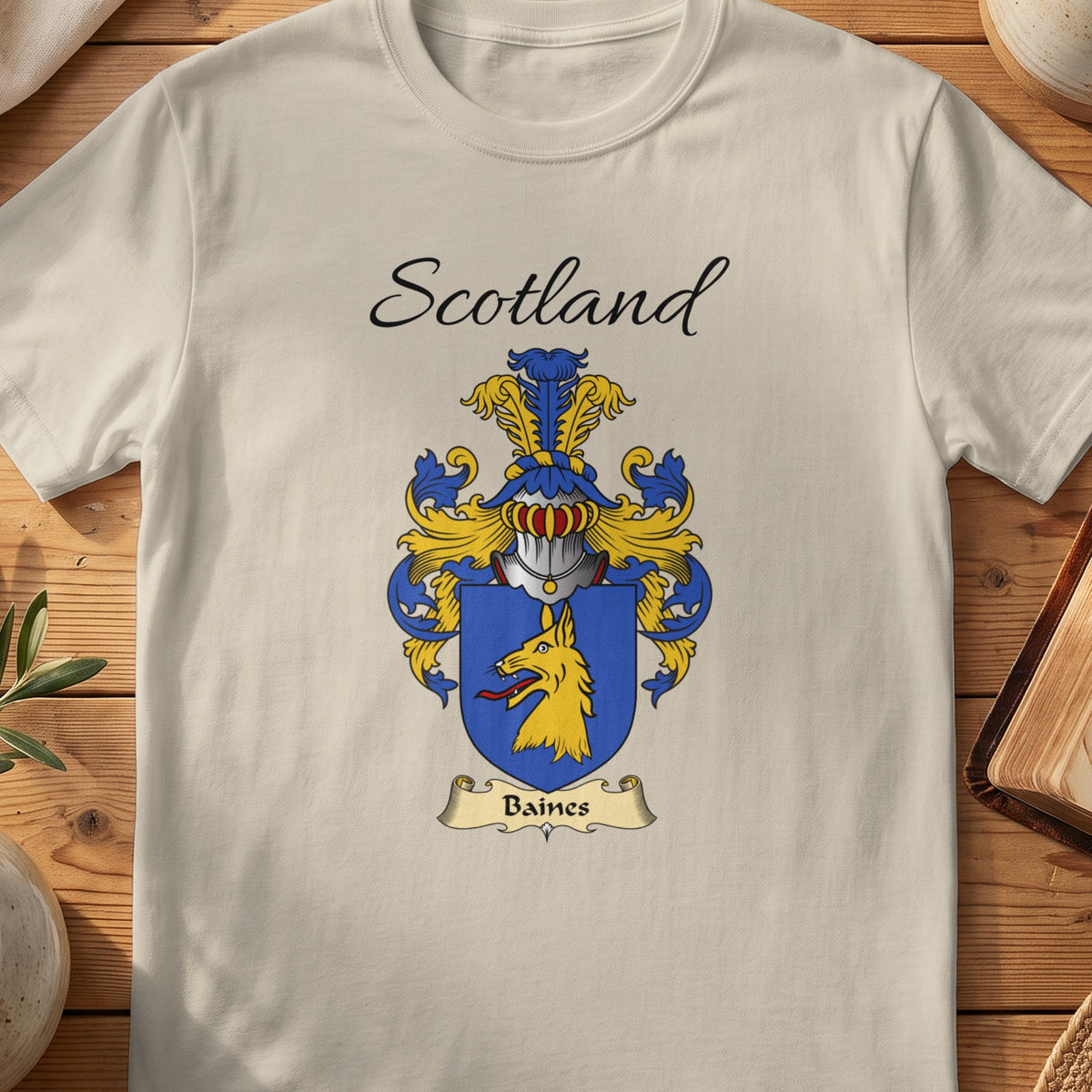 Sand Baines Scottish family shield T-shirt featuring a gold animal head on a blue shield