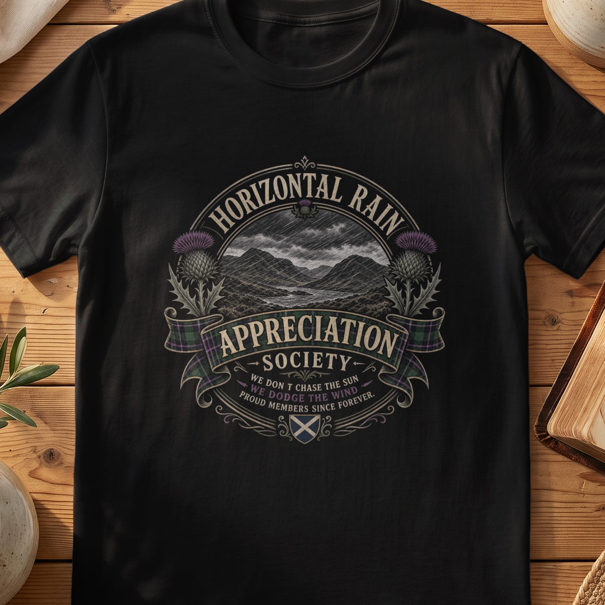 Black Gildan 64000 unisex T-shirt flatlay with Horizontal Rain Appreciation Society Scottish graphic design