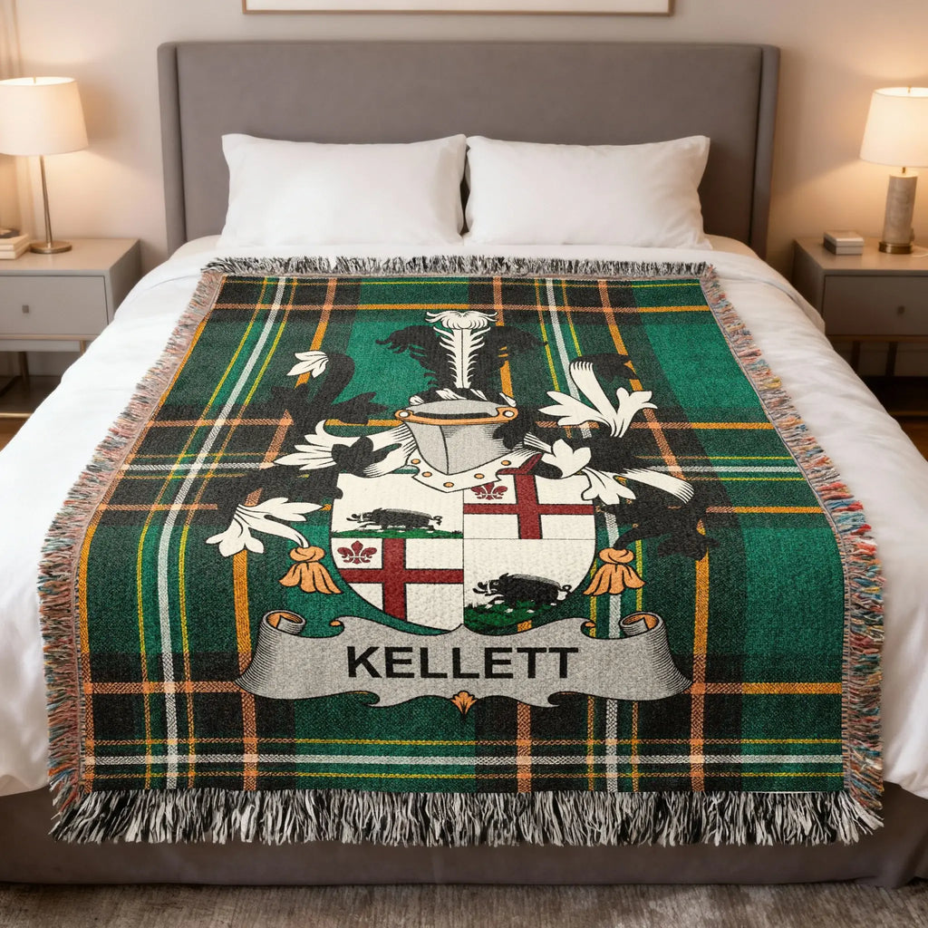Kellett family crest on a green tartan blanket on a bed.