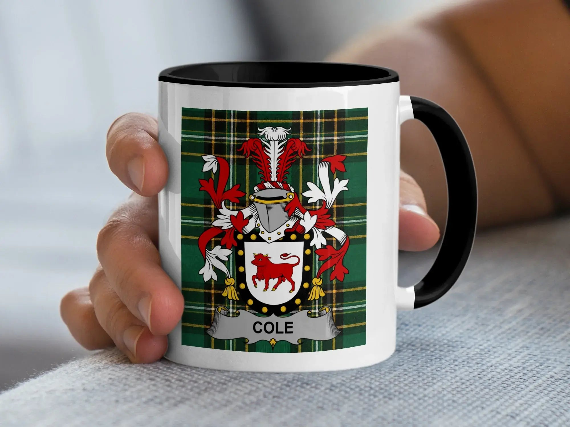 White mug with black rim displaying a green tartan pattern and a family crest with the name "COLE".
