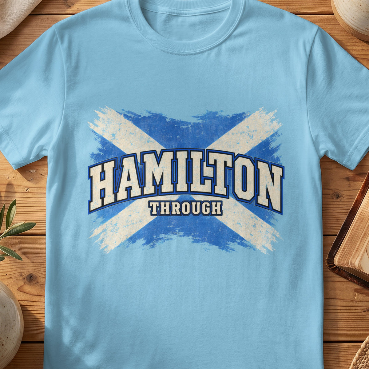Hamilton Scottish Saltire T-shirt in Sky, with distressed blue and cream flag and “Through” lettering.