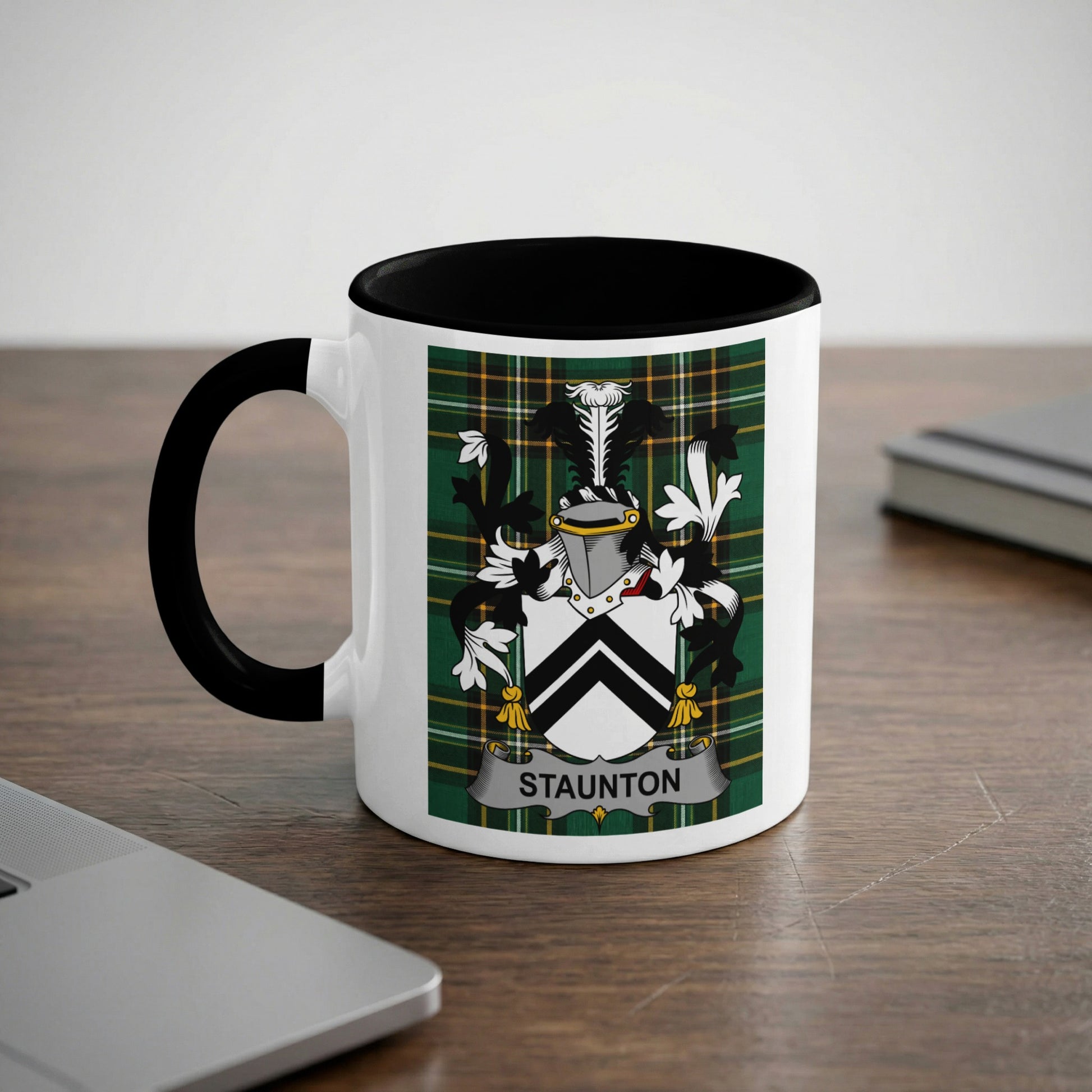 White mug with black rim featuring a green tartan shield with a crest and "Staunton" text.