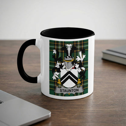 White mug with black rim featuring a green tartan shield with a crest and "Staunton" text.