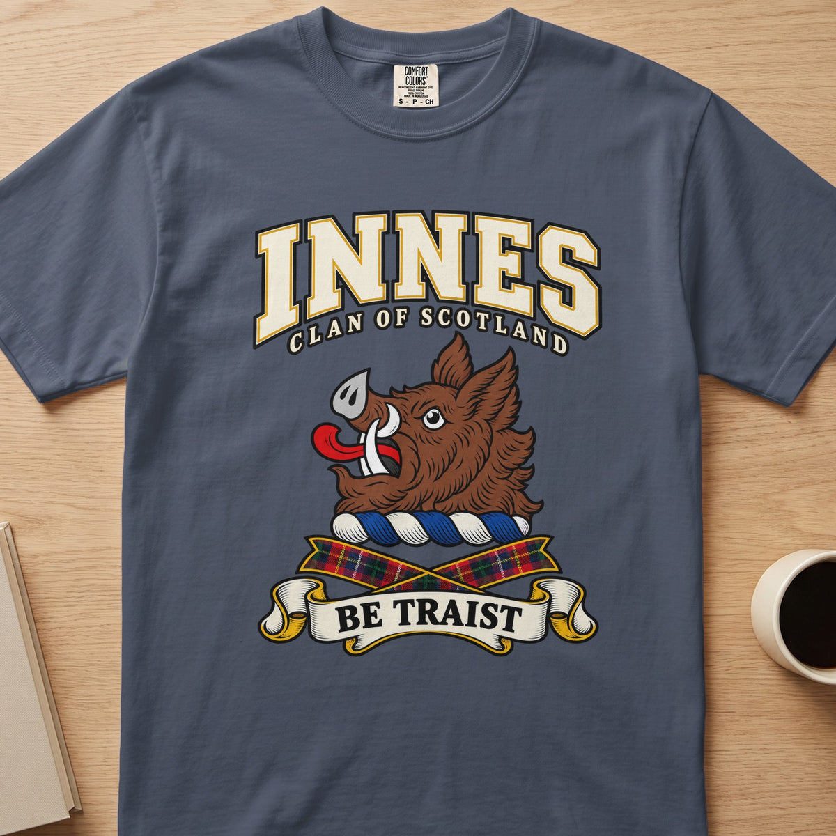 Innes clan crest with brown boar head on a slate blue Comfort Colors T-shirt, front view