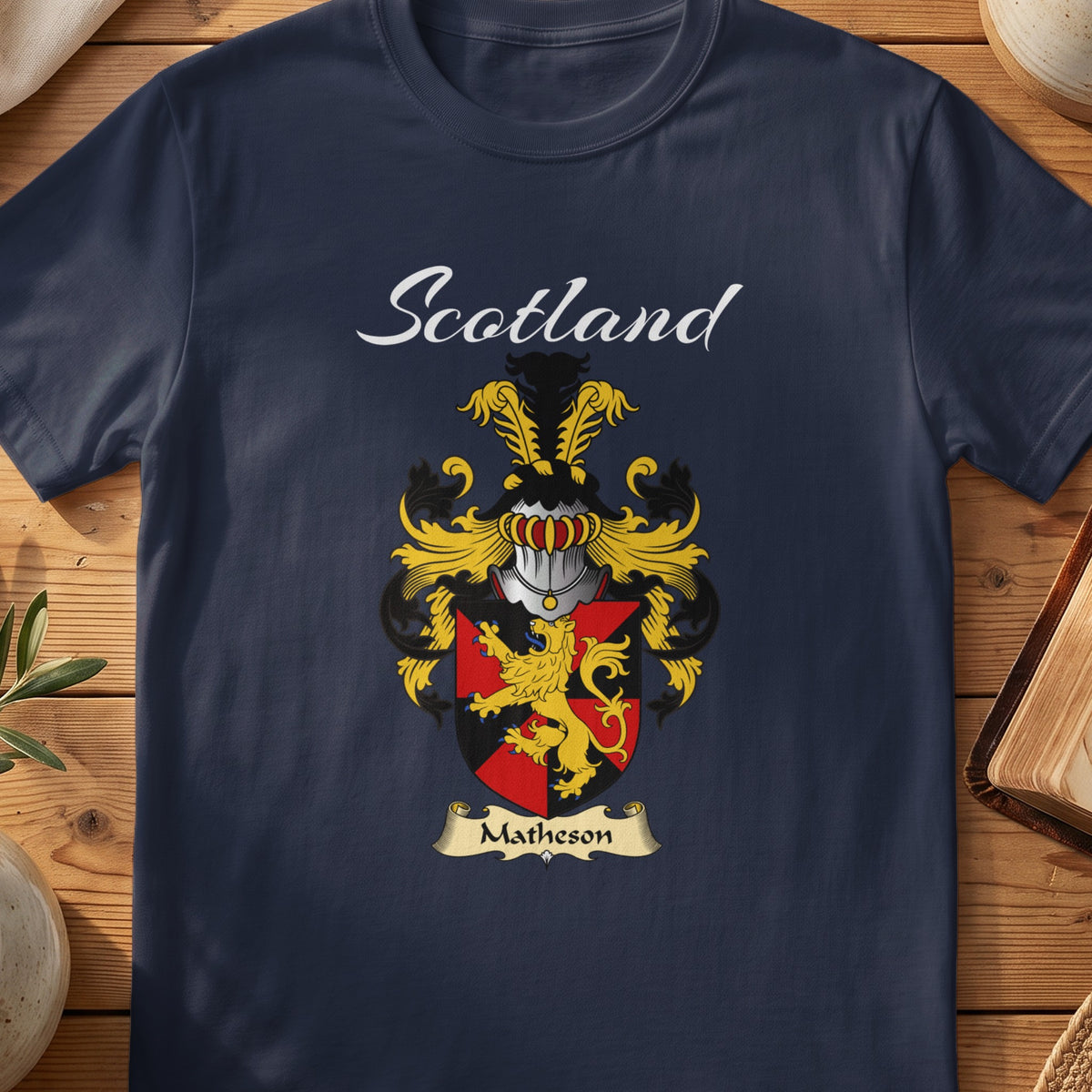 Navy Matheson family shield T-shirt featuring a gold lion across a red-and-black shield