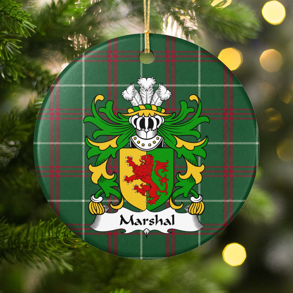 Marshal ornament hanging among Christmas tree branches and warm lights, with a red lion on a gold-and-green divided shield on Welsh National Tartan.